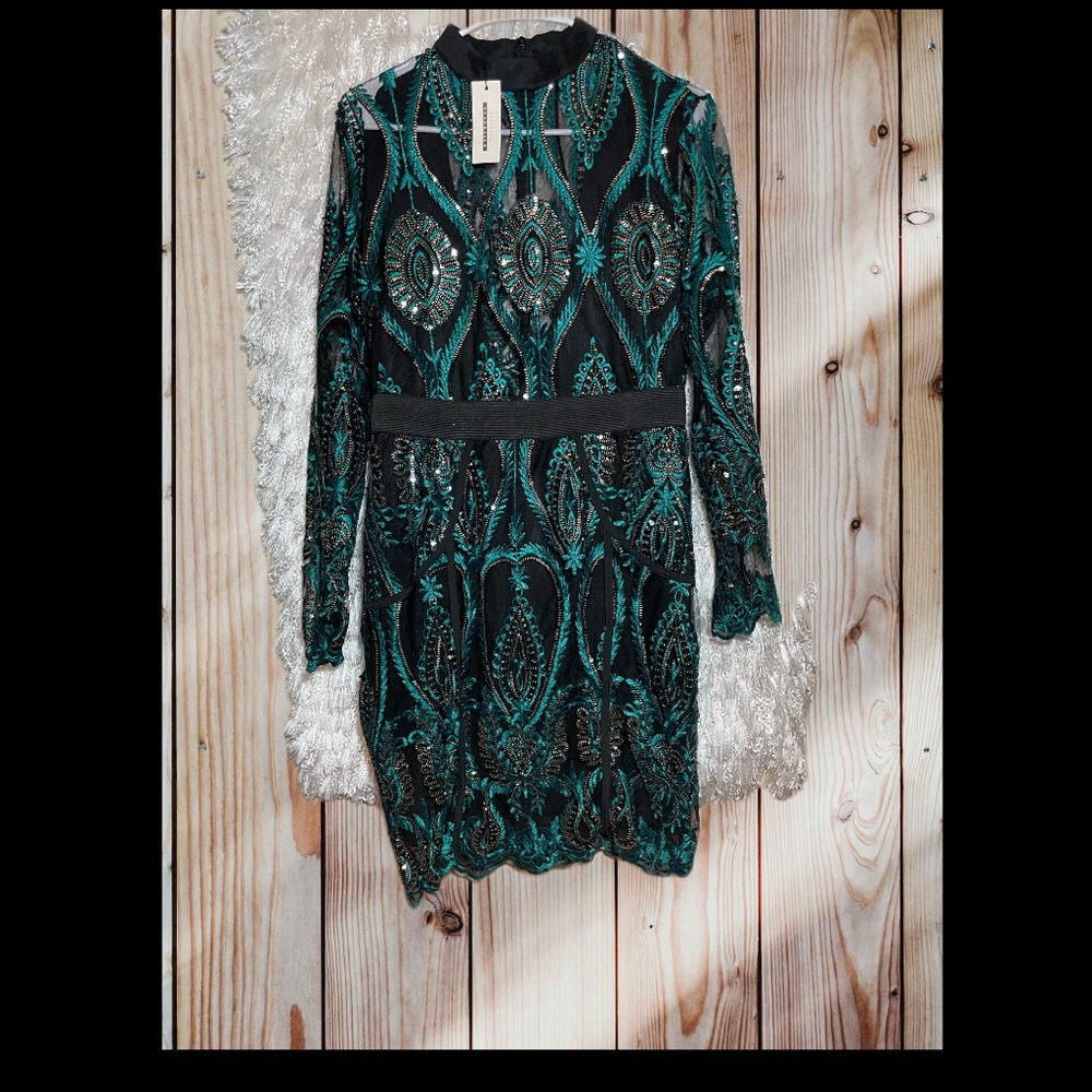 Beautiful peacock sequence dress . Sheer in neck/breast.